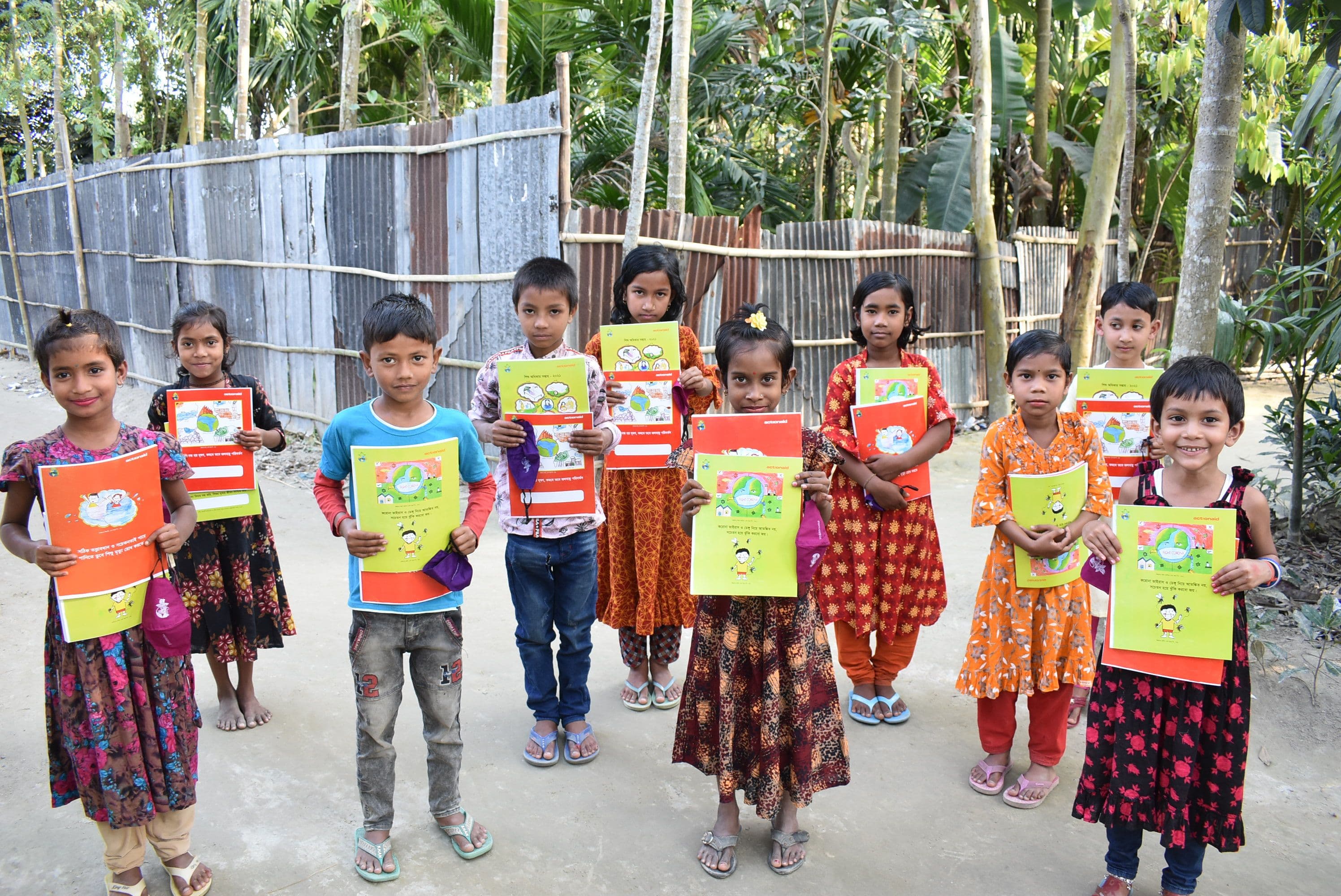 Children are Happy to Receive Colorful Exercise Books and Face Masks